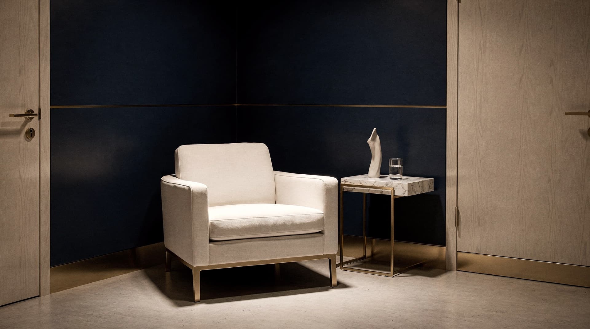 A reserved corner of a premium executive suite, a single armchair and a marble table, a quiet and exclusive atmosphere.